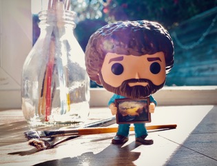 At least Something: Funko Pop Bob Ross and paintbrushes on Ron Sanders' desk